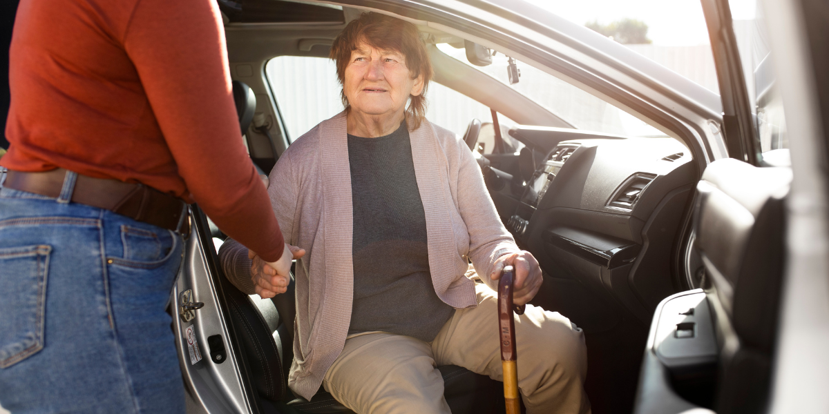 old woman coming out of a taxi